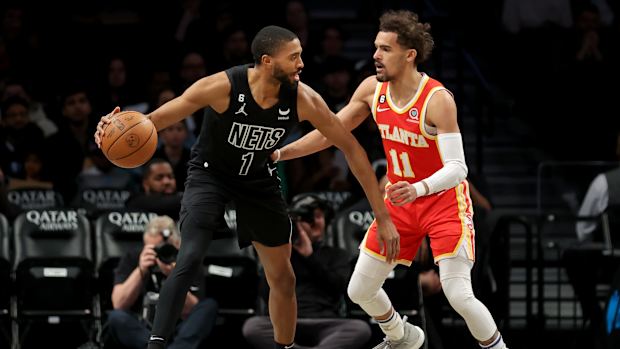 Atlanta Hawks guard Trae Young defends Brooklyn Nets forward Mikal Bridge.
